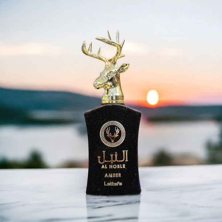 Perfume bottle with deer head design against a sunset landscape lattafa perfumes