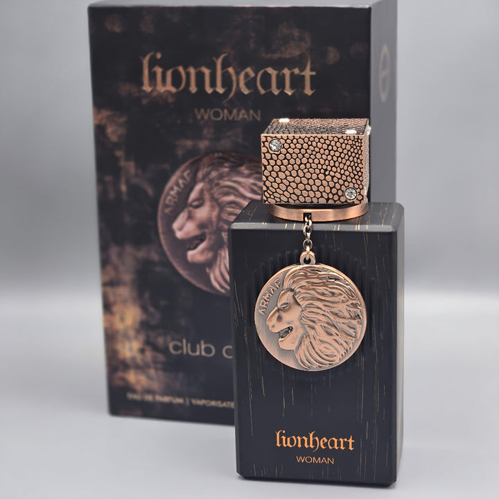 Perfume bottle and packaging of 'lionheart' for women on a gray background