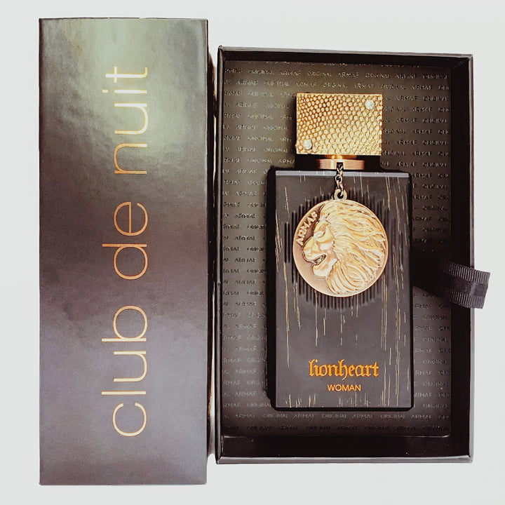 Perfume bottle with lion emblem and packaging labeled 'Club de Nuit Lionheart' on a light gray background
