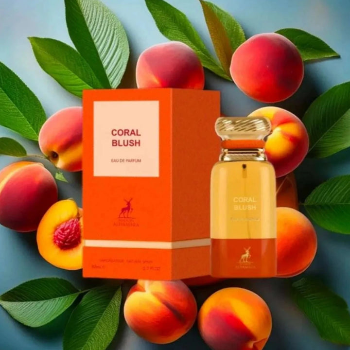 Perfume bottle and packaging with peaches and leaves on a blue background