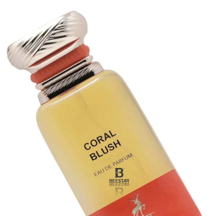 Perfume bottle labeled 'Coral Blush' with a red and yellow design on a white background