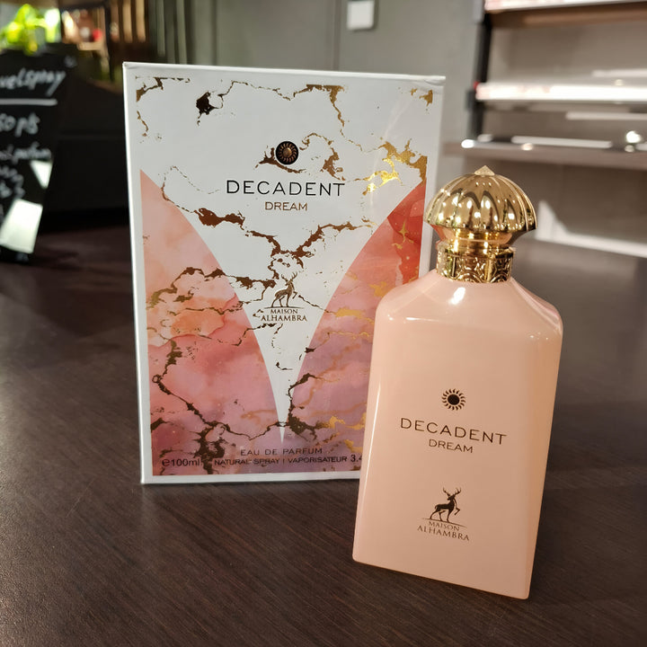 Decadent Dream perfume bottle and packaging on a wooden surface