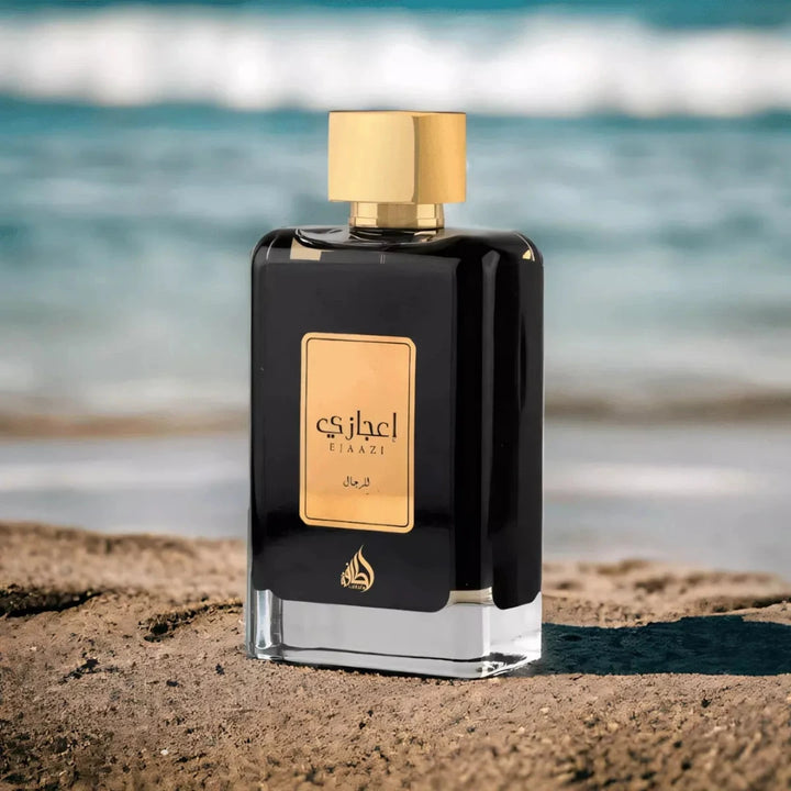 Perfume bottle with gold cap and label on a beach