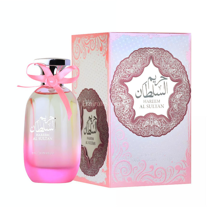 Perfume bottle with pink ribbon and decorative box on a white background