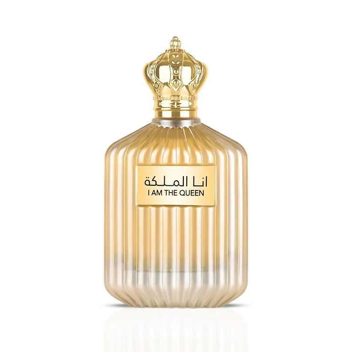 Gold perfume bottle with decorative cap on a white background
