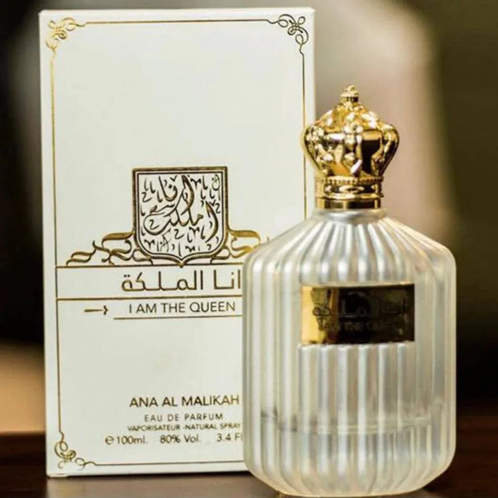 Perfume bottle and packaging of Ana Al Malikah with gold accents on a dark background