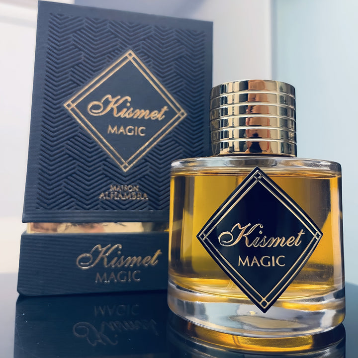 Kismet Magic perfume bottle with packaging on a reflective surface