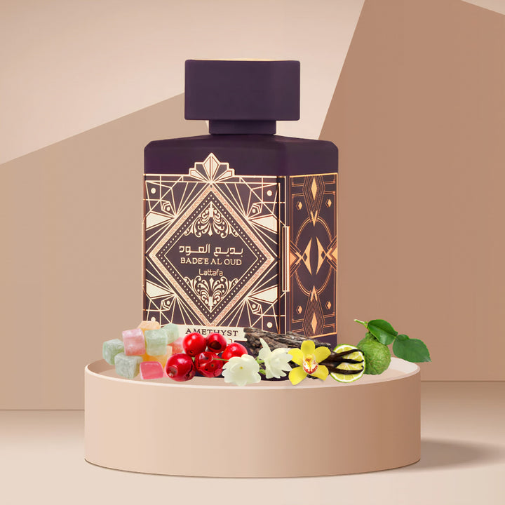 Perfume bottle with decorative design on a beige platform with fruits and flowers Bade'e Al Oud Amethyst Lattafa Perfumes for women and men
