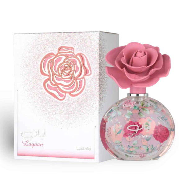 Perfume bottle with pink rose design and matching box on a white background