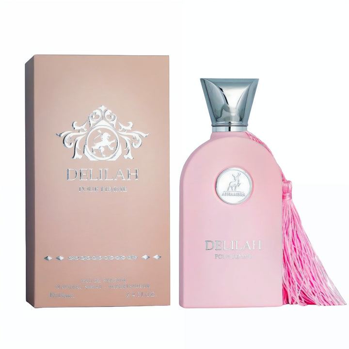 Delilah perfume bottle with pink packaging and tassel next to its box on a white background