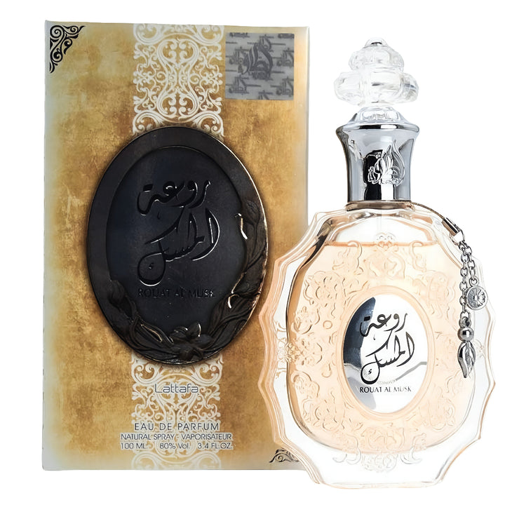 Perfume bottle and packaging with intricate design on a white background