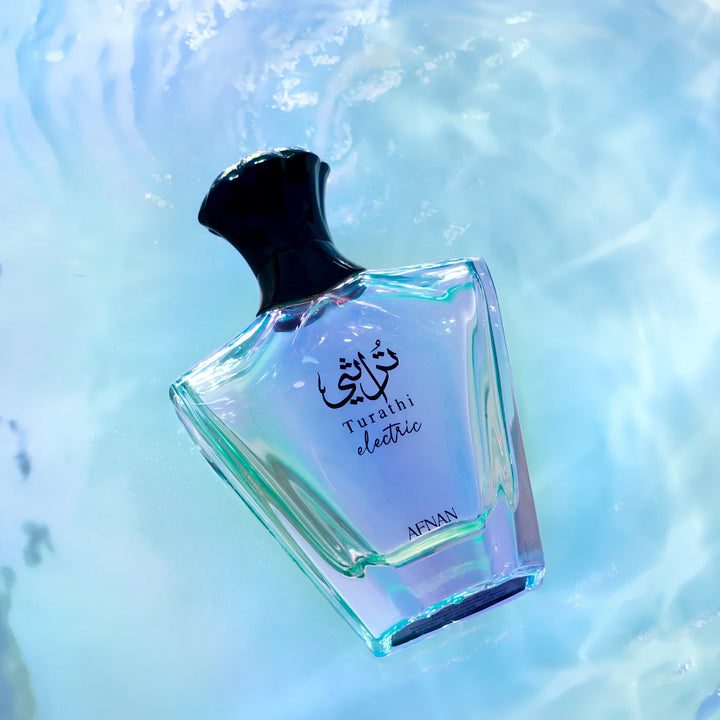 Perfume bottle labeled 'Turath electric' by 'APFAN' on a light blue background