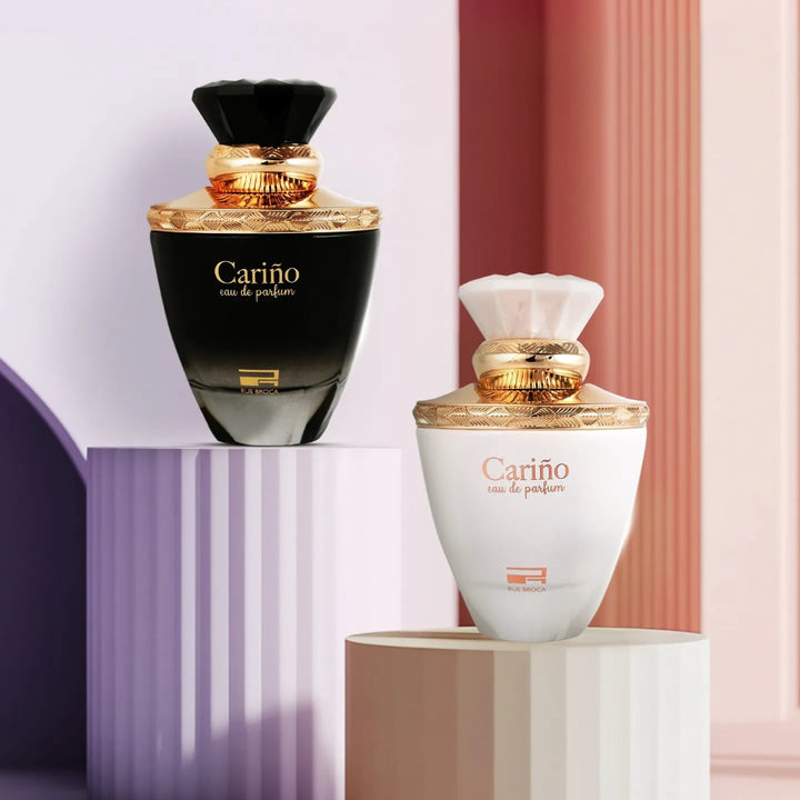 Two Cariño perfume bottles on geometric podiums with a colorful background