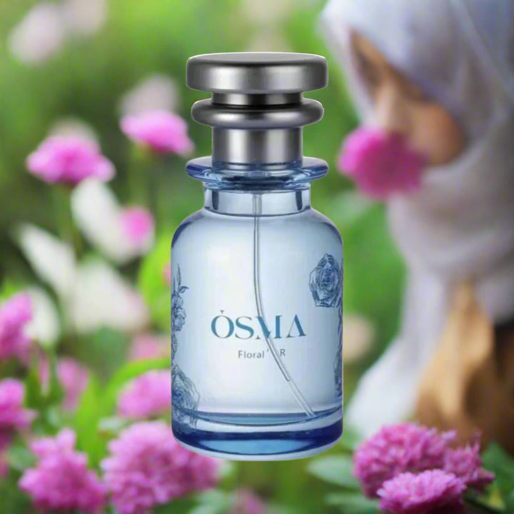 Blue perfume bottle with silver cap on a white background