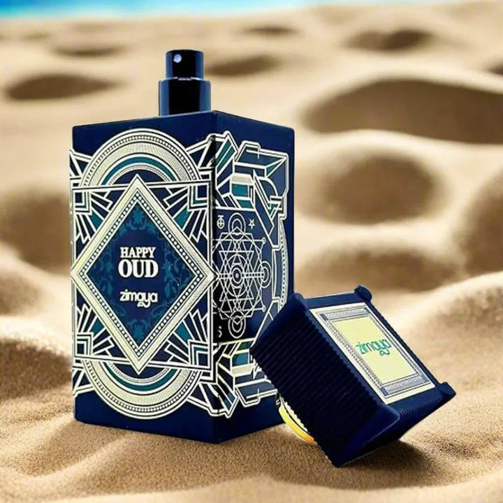 Perfume bottle and packaging with 'Happy Oud' branding on a sandy background