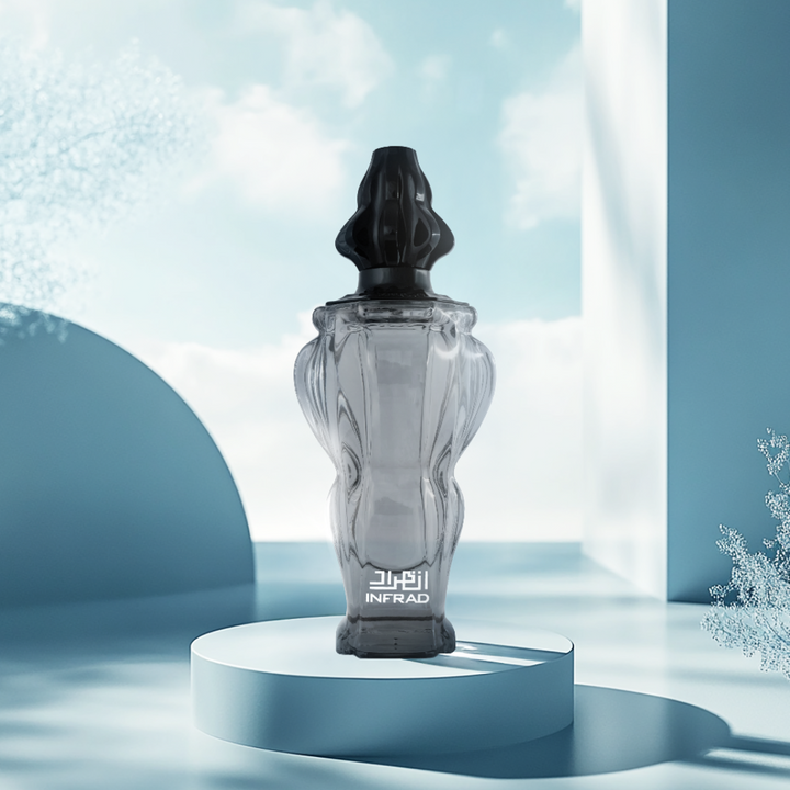 Glass perfume bottle with black cap on a white pedestal against a light blue background