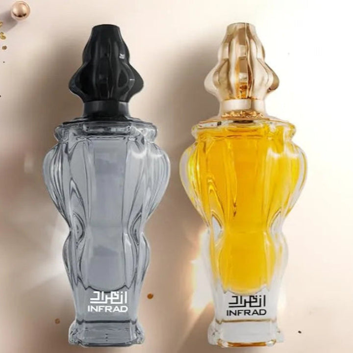 Two perfume bottles, one gray and one yellow, on a decorative background with gold accents.