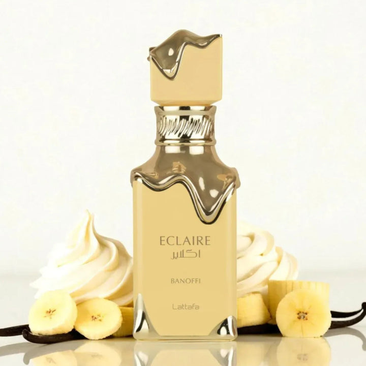 Eclaire Banoffi Latte perfume bottle with vanilla beans and cream on a light background