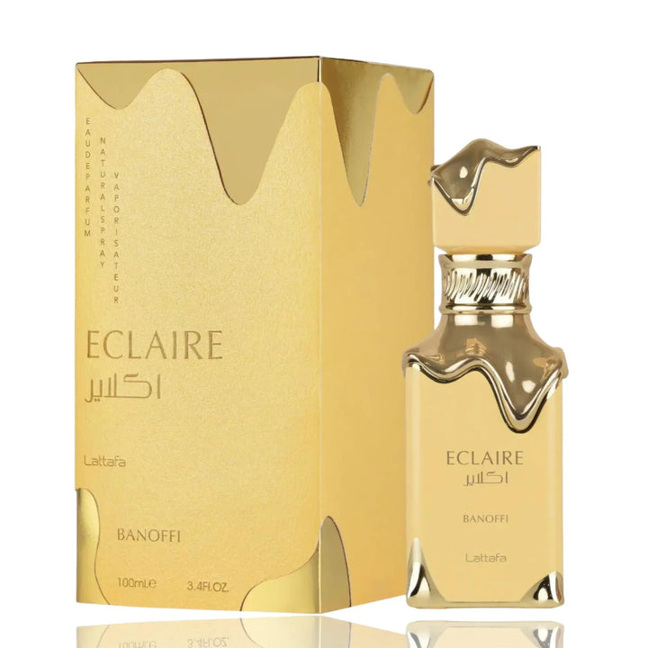Gold Eclaire perfume bottle and packaging on a white background