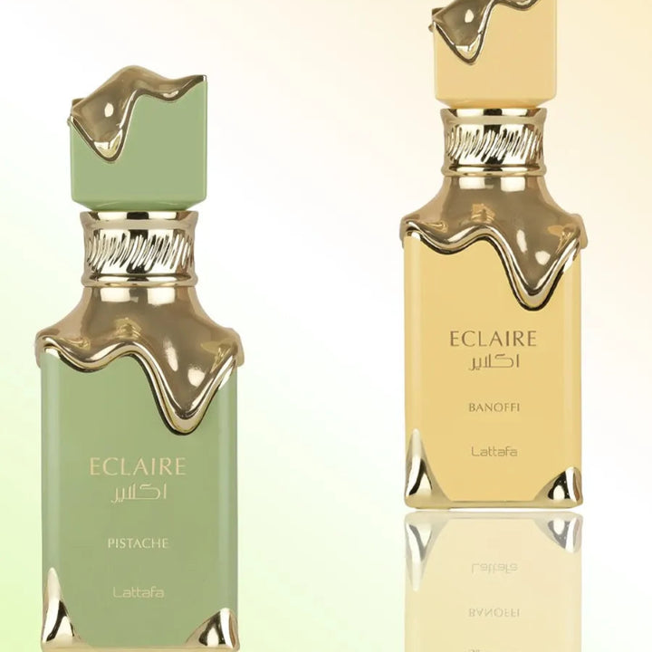 Two Eclaire perfume bottles, one green and one gold, on a light background.