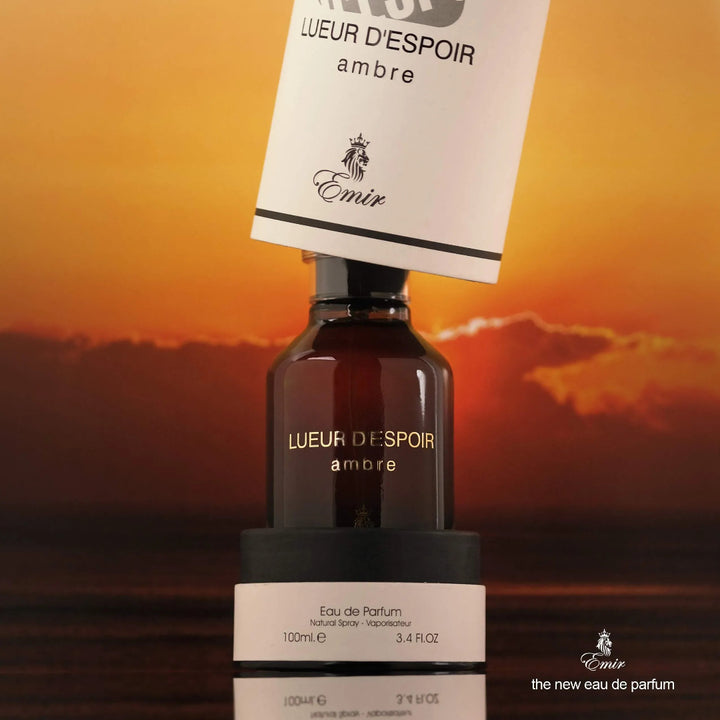Lueur d'Espoir Ambre perfume bottle with sunset background