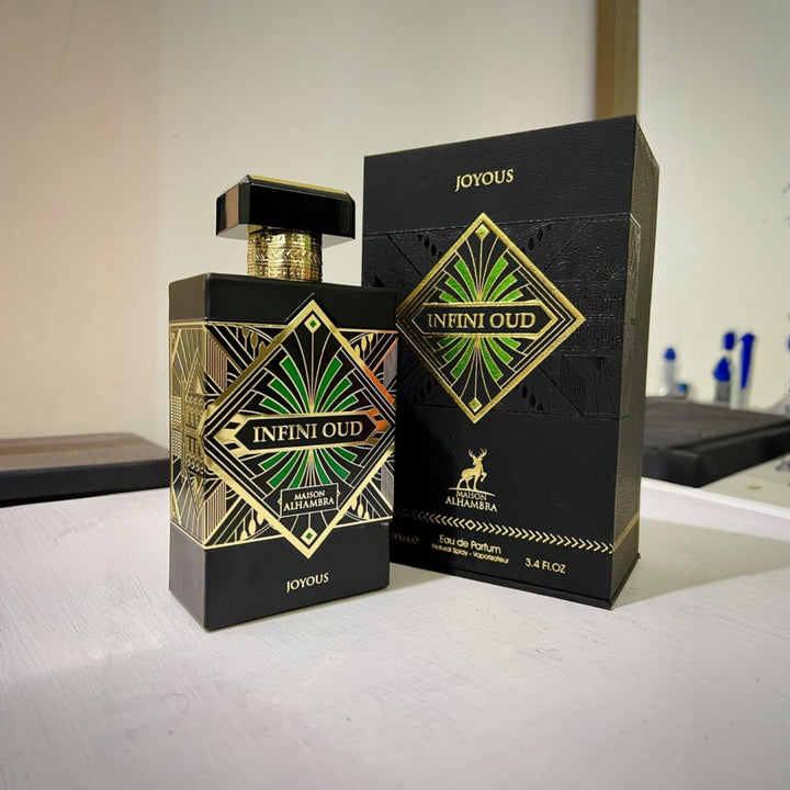 Infini Oud perfume bottle and packaging on a white surface