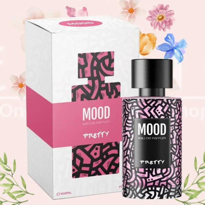 Perfume bottle and packaging with 'Exotic Mood Pretty' branding on a pink background with flowers and leaves.