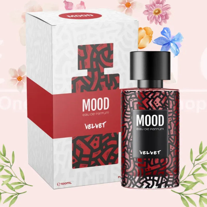 Mood Velvet perfume bottle and packaging on a pink background with floral elements.