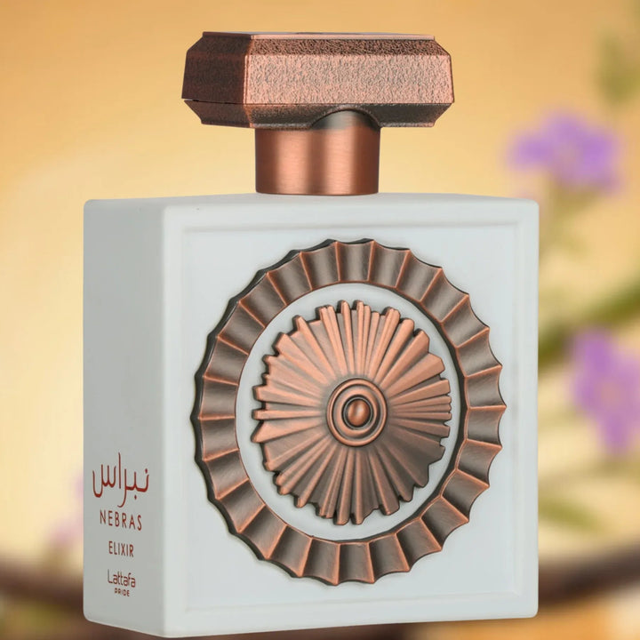 Nebras Elixir perfume bottle with decorative design on a blurred floral background