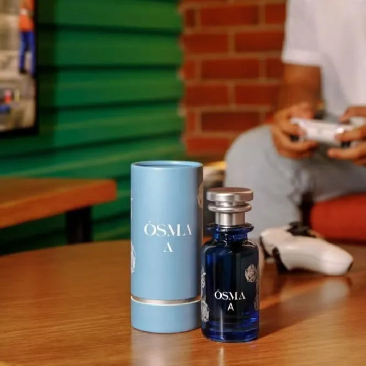 Osmia perfume bottle and packaging on a table with a blurred background
