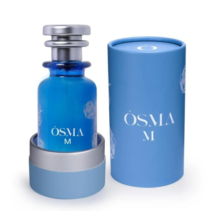 Blue Osma M perfume bottle with matching cylindrical container on a white background