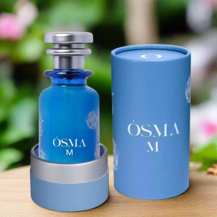 Blue Osma M perfume bottle with matching cylindrical container on a white background