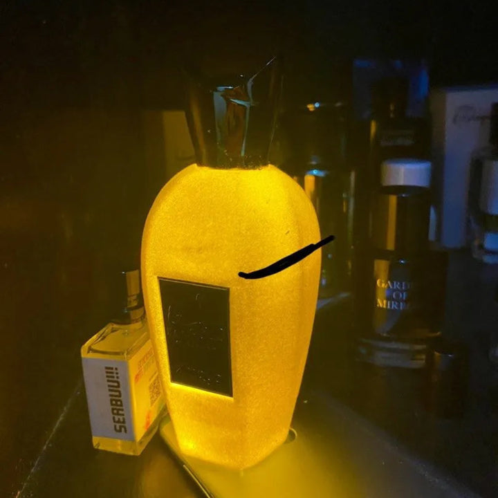 rabab pulp zimaya object on a dark surface with bottles in the background