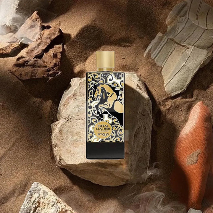 Perfume bottle with decorative label on a rocky surface