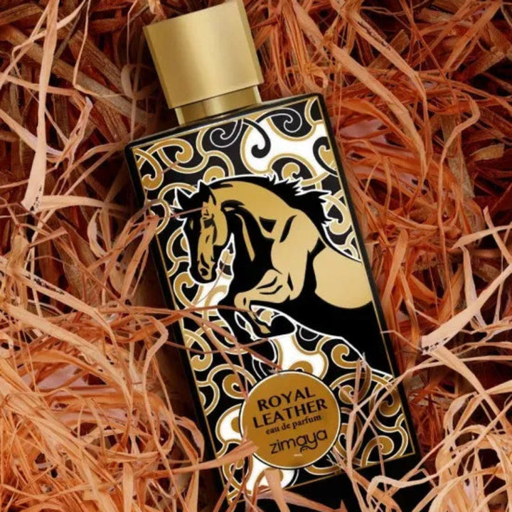 Perfume bottle with gold and black design on a textured orange background