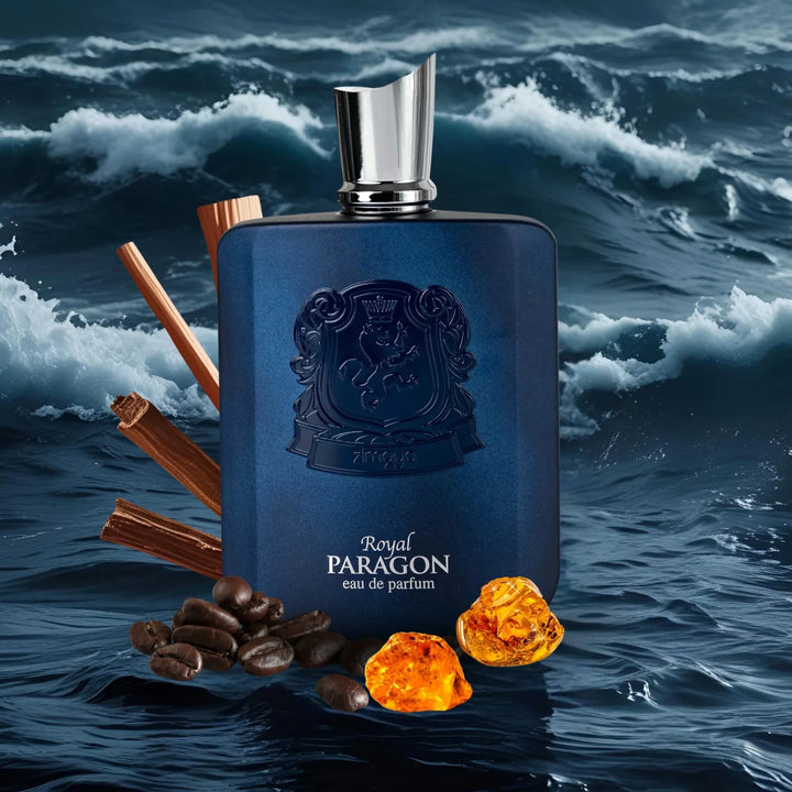 Blue perfume bottle with 'Royal Paragon' branding on a water background with spices and amber.