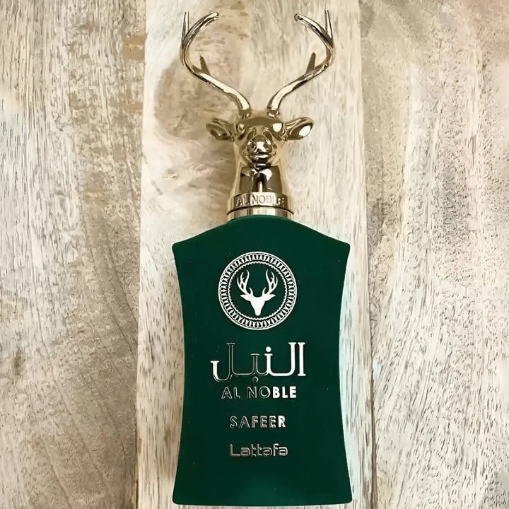 Green perfume bottle with deer design on a textured beige background
