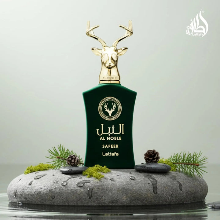 Green perfume bottle with gold deer head on a gray stone platform with greenery