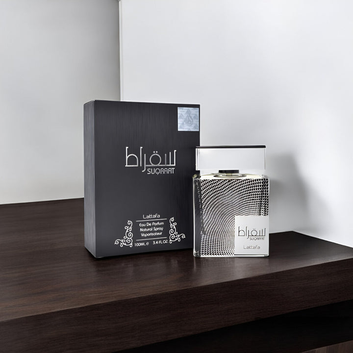 Perfume bottle and packaging suqraat lataffa on a wooden surface with a white background