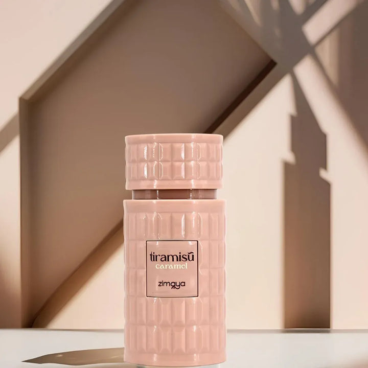 Pink bottle labeled 'tiramisu caramel' by Zingya on a neutral background