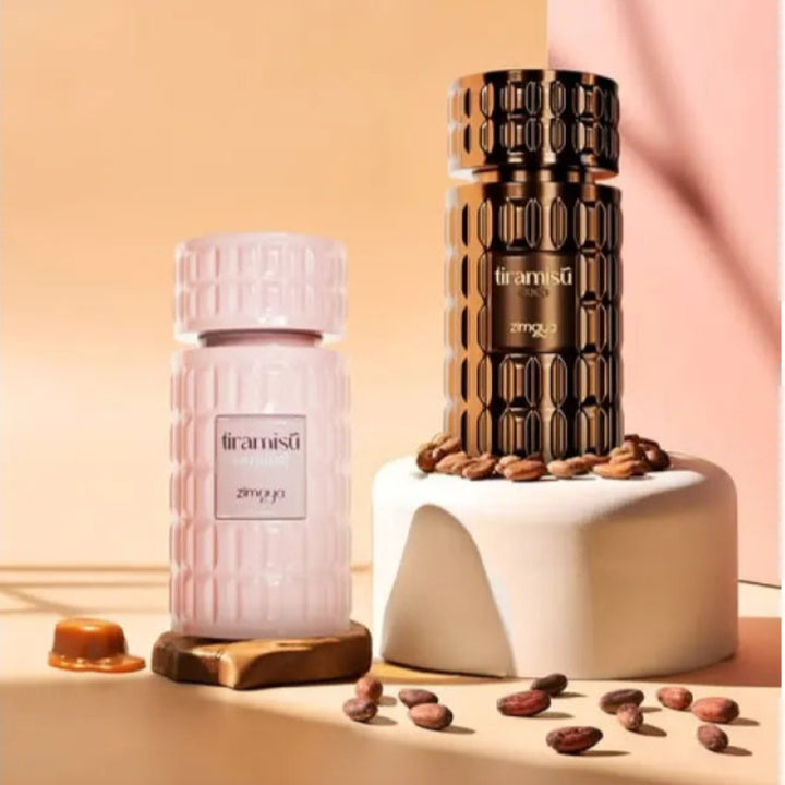 Two perfume bottles, one pink and one black with gold accents, on a beige background.