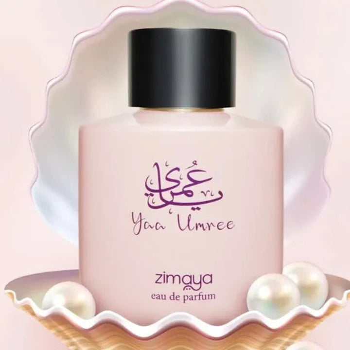Zimaya eau de parfum bottle with decorative shell and pearls on a light pink background